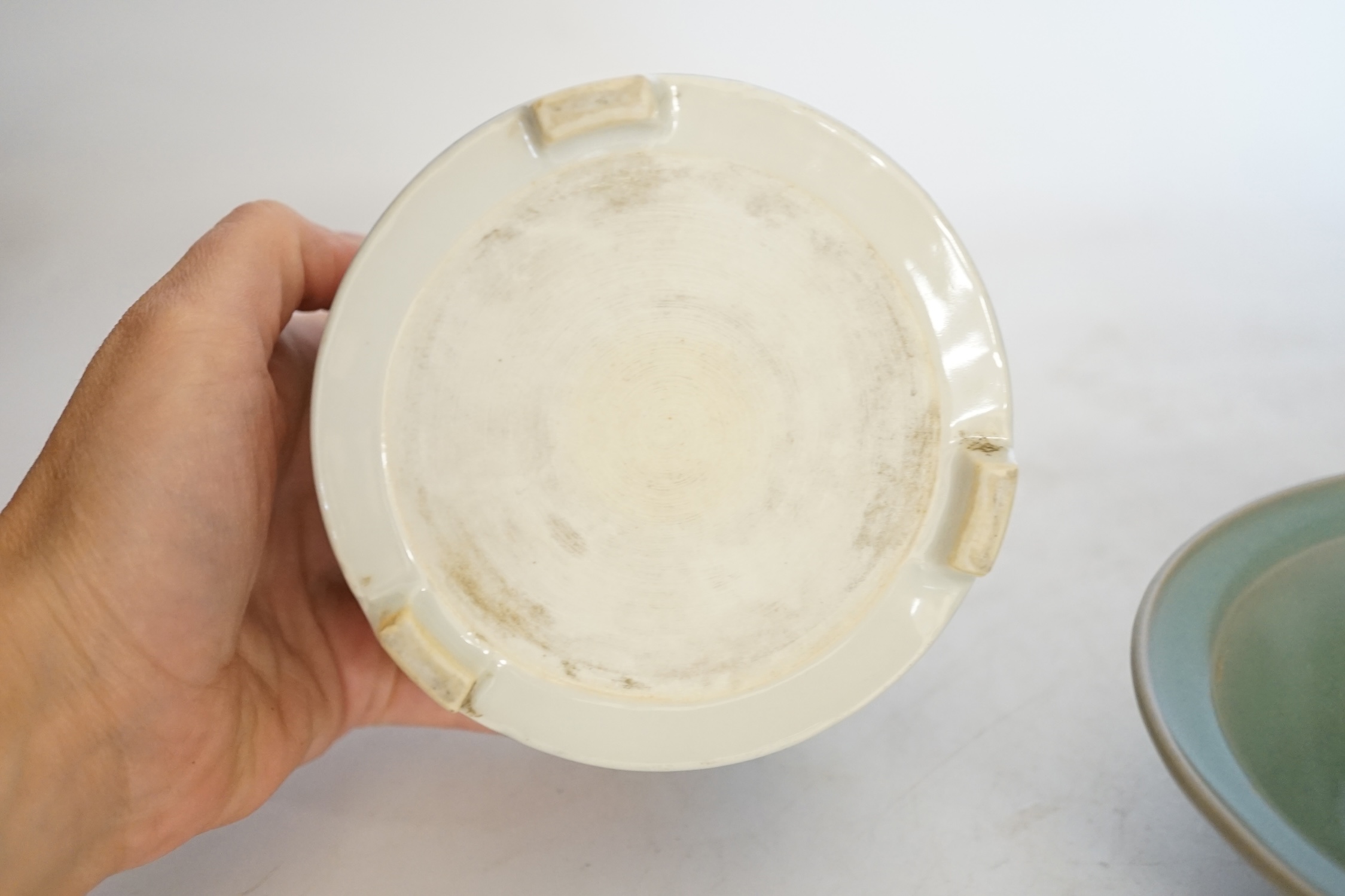 A Chinese blue and white footed brushpot and celadon glazed ‘fish’ bowl, tallest 9cm. Condition - good